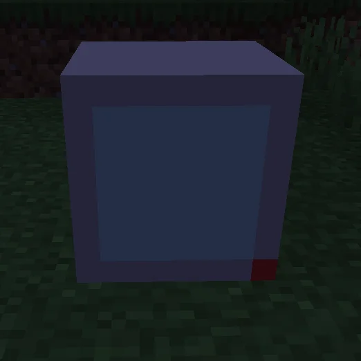 The PC Block on top of a piece of grass blocks, with a grass block on the image corner.
